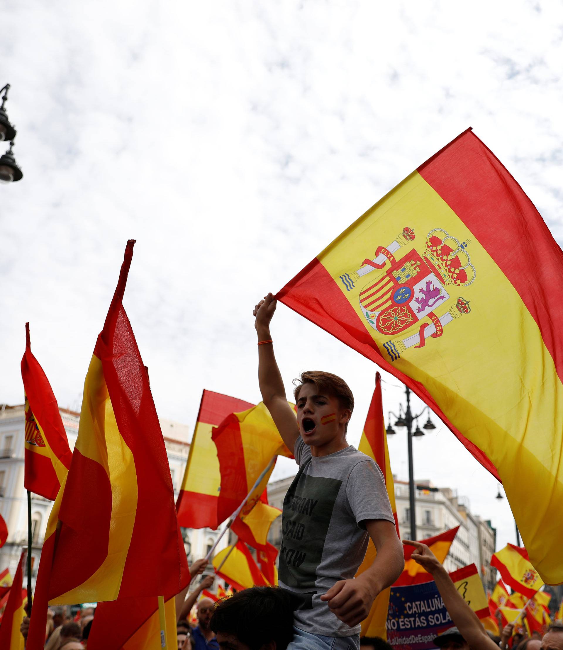 Demonstrators wave Spanish flags during a demonstration in favor of a unified Spain on the day of a banned independence referendum in Catalonia, in Madrid