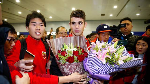 Brazilian international midfielder Oscar arrives at the Shanghai Pudong International Airport, after agreeing to join China super league football club Shanghai SIPG from Chelsea in Shanghai