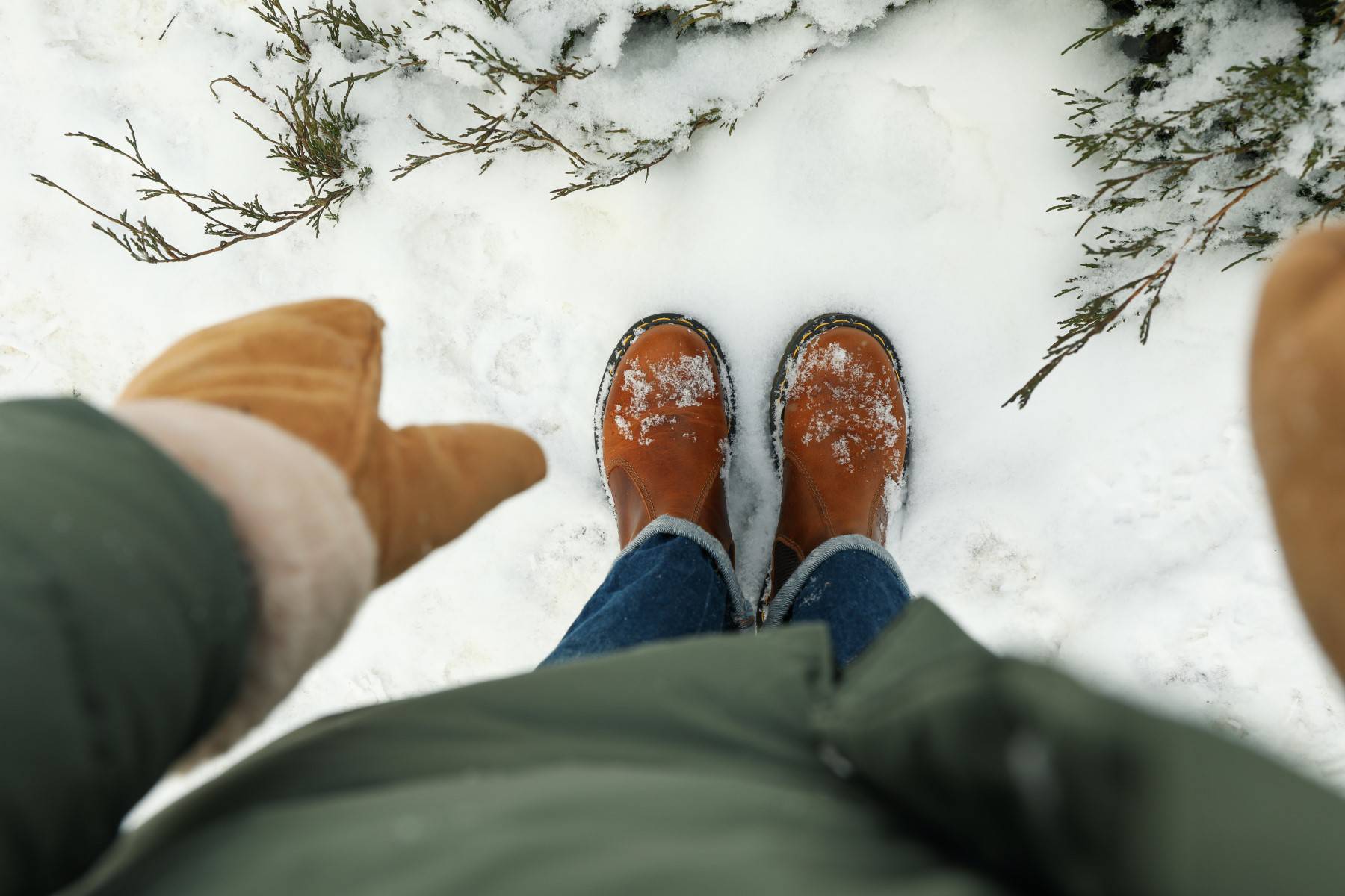 Woman in jeans and boots standing outdoor in winter