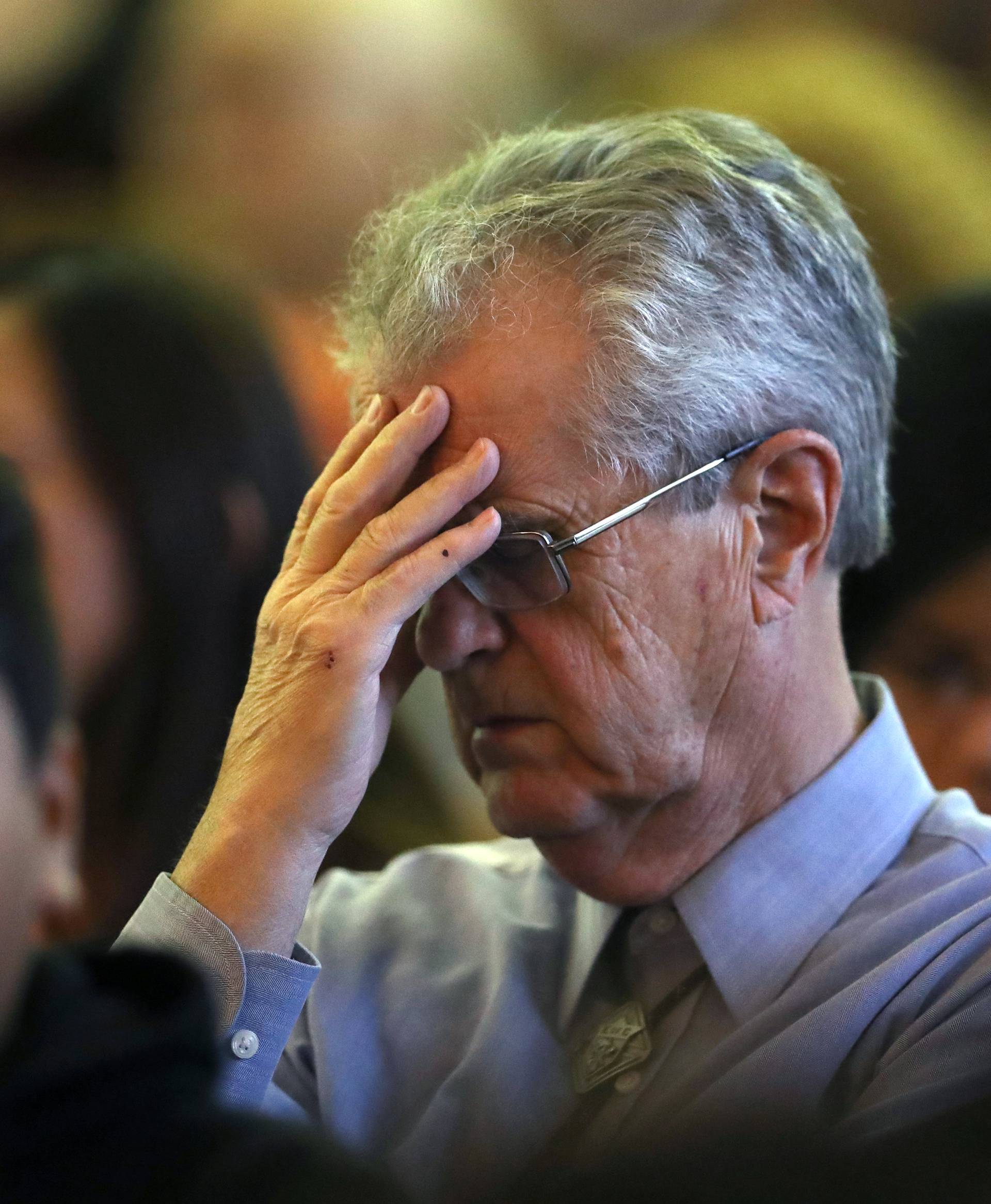 A man mourns during an interfaith memorial service for victims of the Route 91 music festival mass shooting outside the Mandalay Bay Resort and Casino in Las Vegas