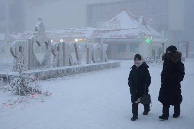 People walk along a street on a frosty day in Yakutsk