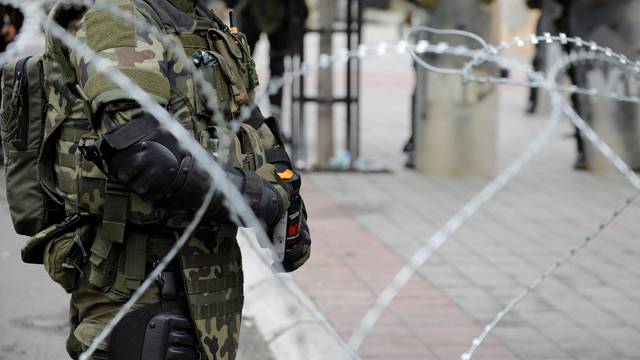 Polish members of the NATO-led Kosovo Force (KFOR) stand guard near a municipal office in Zvecan