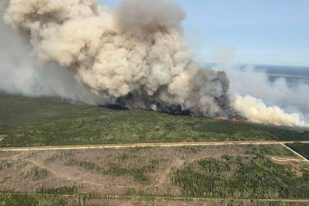 Smoke rises a wildfire near Wanless, Manitoba