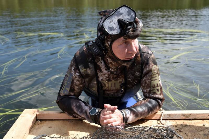 Russian President Vladimir Putin rests after swimming during the hunting and fishing trip which took place on August 1-3 in the republic of Tyva in southern Siberia