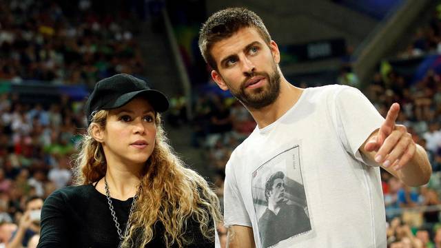 FILE PHOTO: Colombian singer Shakira and her partner, Barcelona soccer player Pique, attend the Basketball World Cup quarter-final game between the U.S. and Slovenia in Barcelona