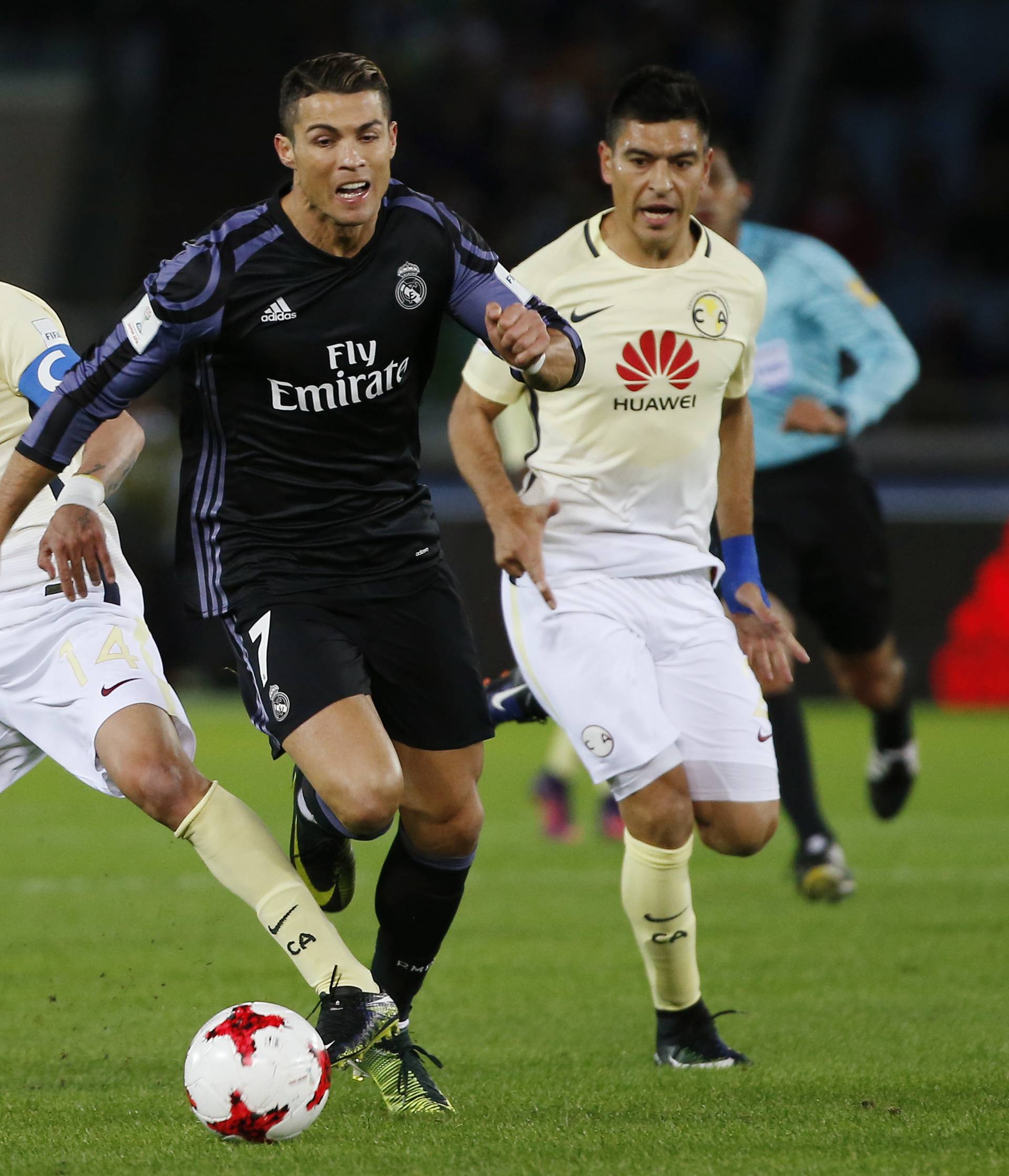 Real Madrid's Cristiano Ronaldo in action with Club America's Rubens Sambueza