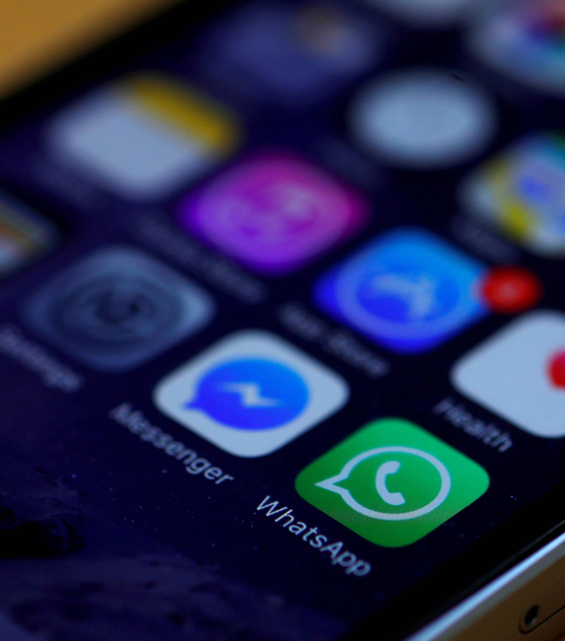 FILE PHOTO: WhatsApp and Facebook messenger icons are seen on an iPhone in Manchester , Britain.