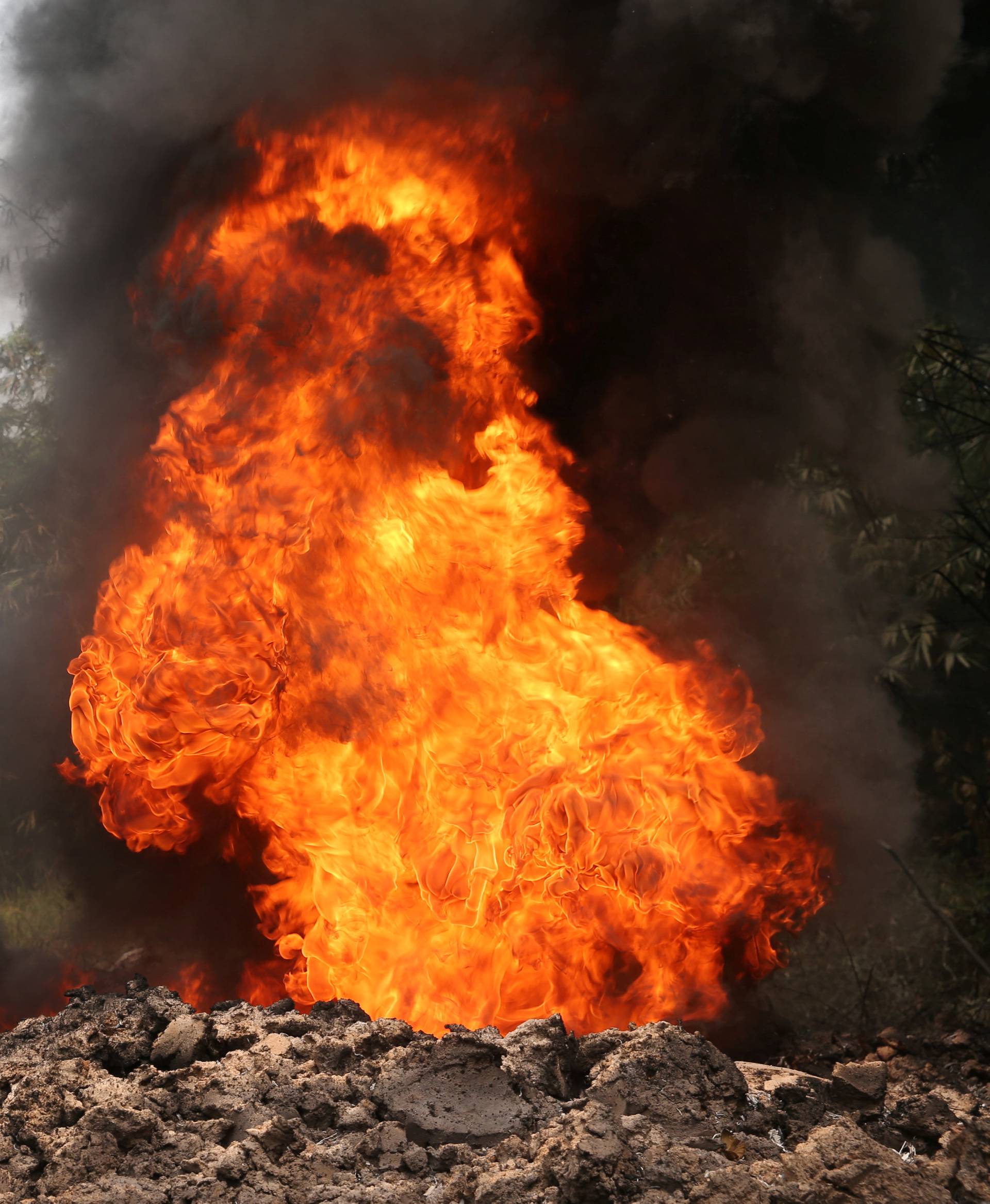 Fire burns on the Shell Petroleum Development Company Trans Niger pipeline at Mogho