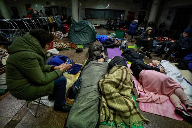 People take shelter inside a metro station during a Russian missile and drone attack in Kyiv