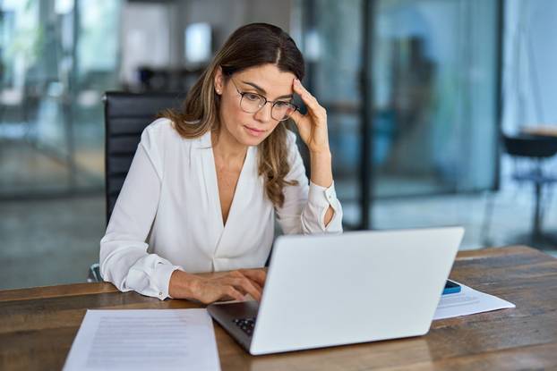 Fatigued,Worried,Mature,Business,Woman,Wearing,Glasses,Having,Headache,At