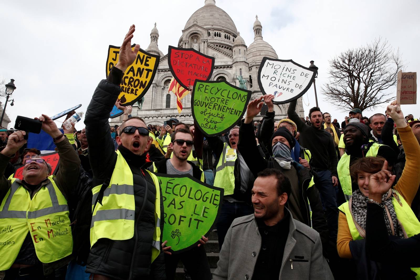 Protesters wearing yellow vests attend a demonstration in front of the Sacre-Coeur Basilica of Montmartre during the Act XIX (the 19th consecutive national protest on Saturday) of the "yellow vests" movement in Paris