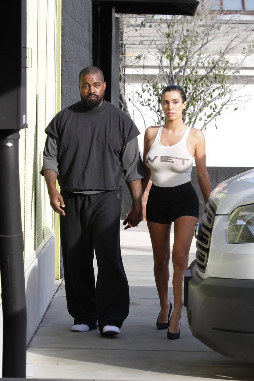 *PREMIUM-EXCLUSIVE* Kanye West sports hotel slippers while Bianca Censori steps out braless in "WET'' t-shirt for tanning session in Melrose Place
