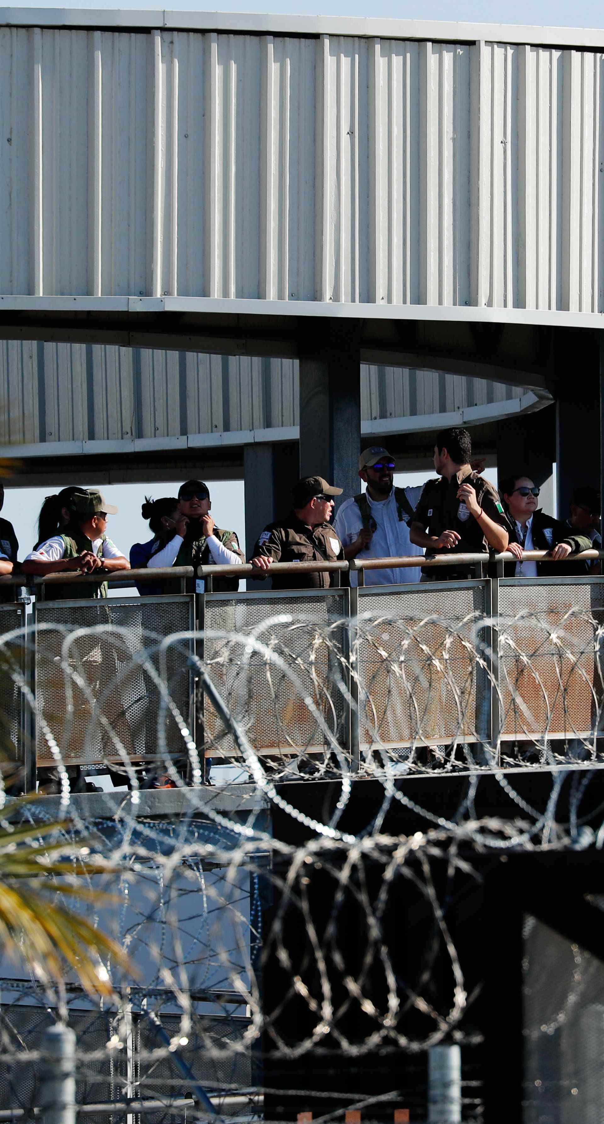 People wait at the Mexican entrance to the San Ysidro border crossing after the border between Mexico and the U.S. was closed in the San Ysidro neighborhood of San Diego