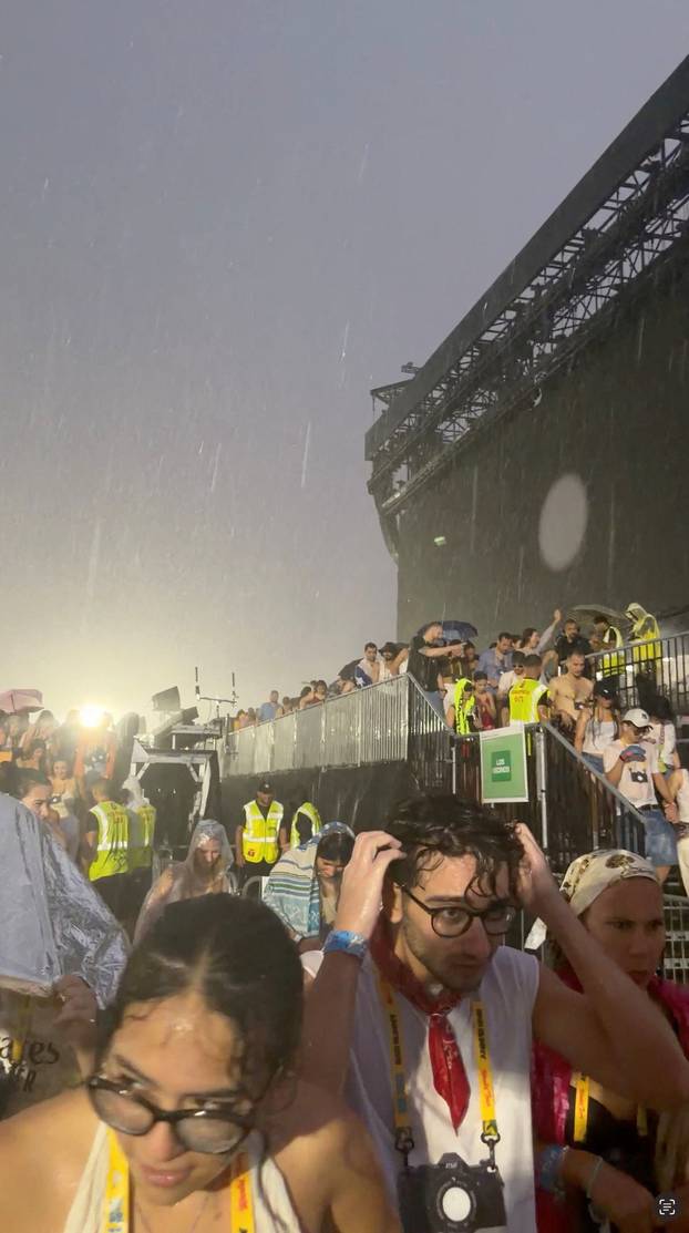 People evacuate from Bad Bunny's concert due to a hailstorm, in Milan