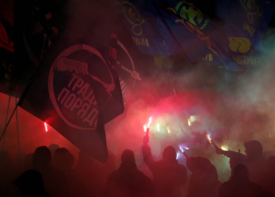 Activists of opposition parties burn flares during a rally demanding to break an agreement with Russia on the use of the Azov Sea and the Kerch Strait, in front of the parliament building in Kiev