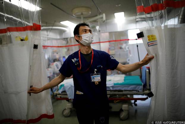 FILE PHOTO: Doctor draws curtain in critical care ward at Yokohama hospital