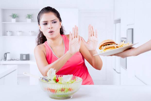 Indian woman refusing hamburger