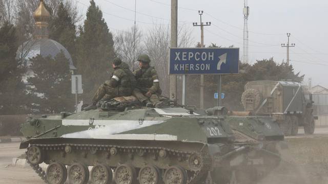 An armoured vehicle drives along a street in Armyansk