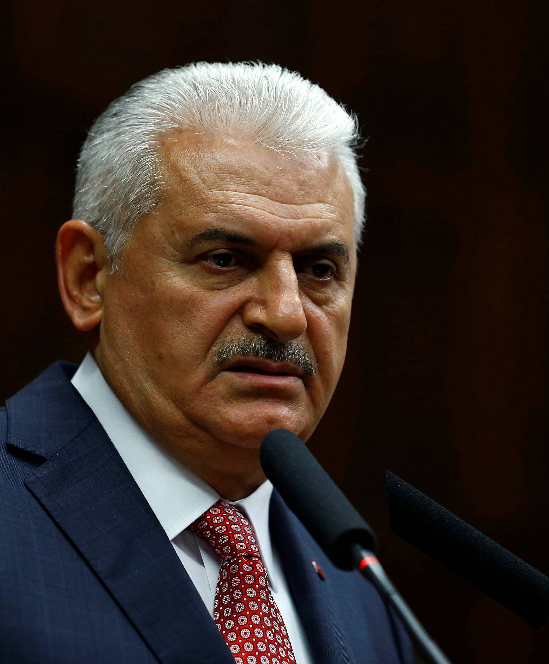 Turkey's Prime Minister Binali Yildirim addresses members of parliament from his ruling AK Party during a meeting at the Turkish parliament in Ankara