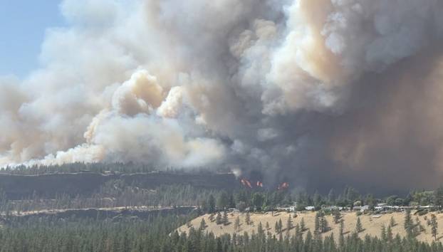 Massive plumes of smoke rise from a wildfire in Spokane