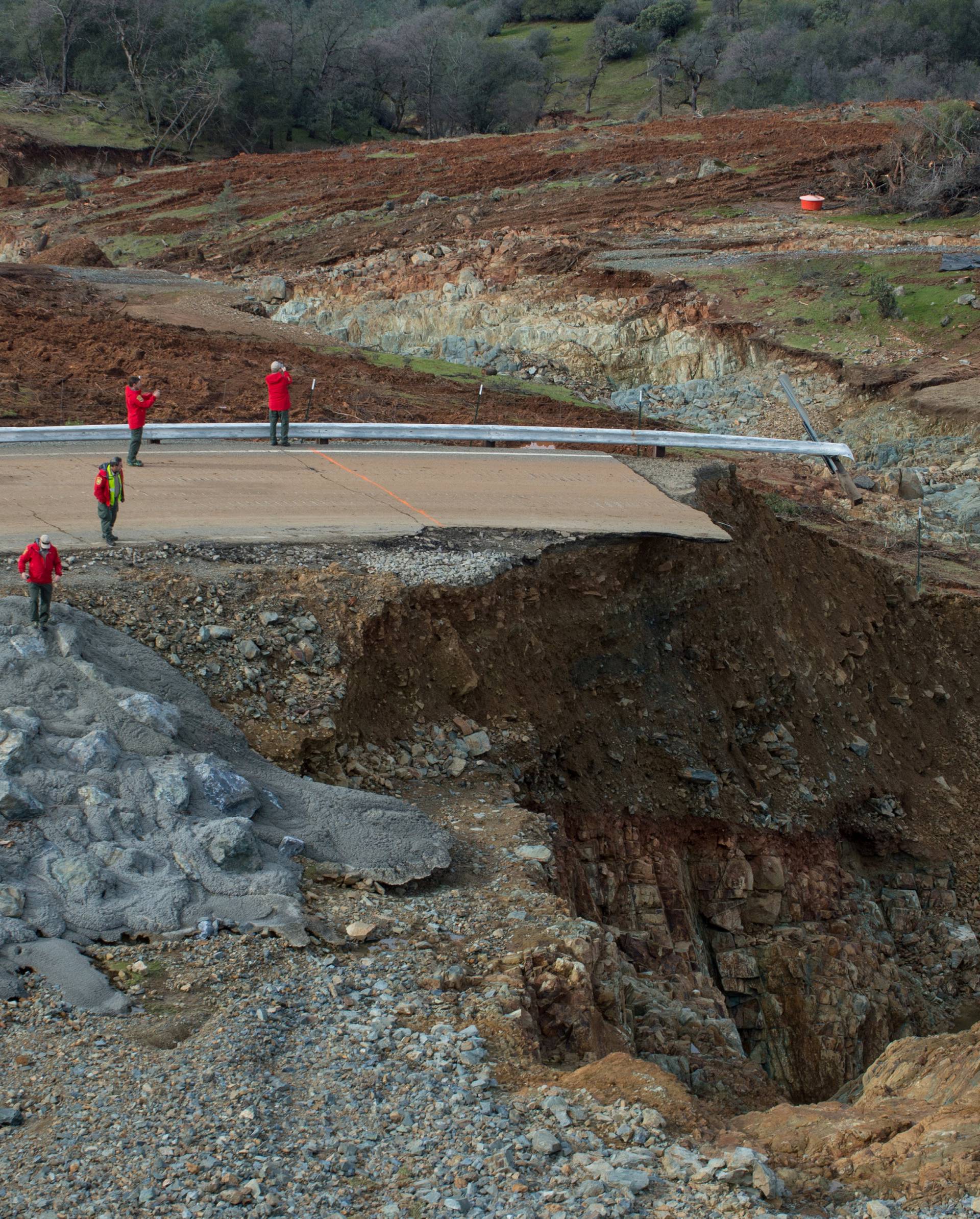 Handout photo of California Department of Water Resources crews inspect and evaluate the erosion just below the Lake Oroville Emergency Spillway site after lake levels receded, in Oroville