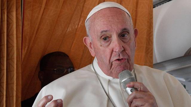 Pope Francis speaks to the media on board an Alitalia aircraft