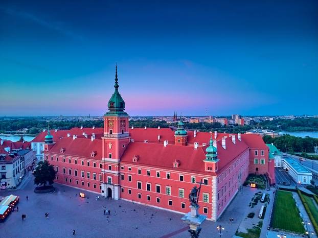 Beautiful panoramic aerial drone view on Warsaw Old town (POL: Stare Miasto) - the oldest district of Warsaw (13th century), Royal Castle, square and the Column of Sigismund III Vasa at sunset, Poland