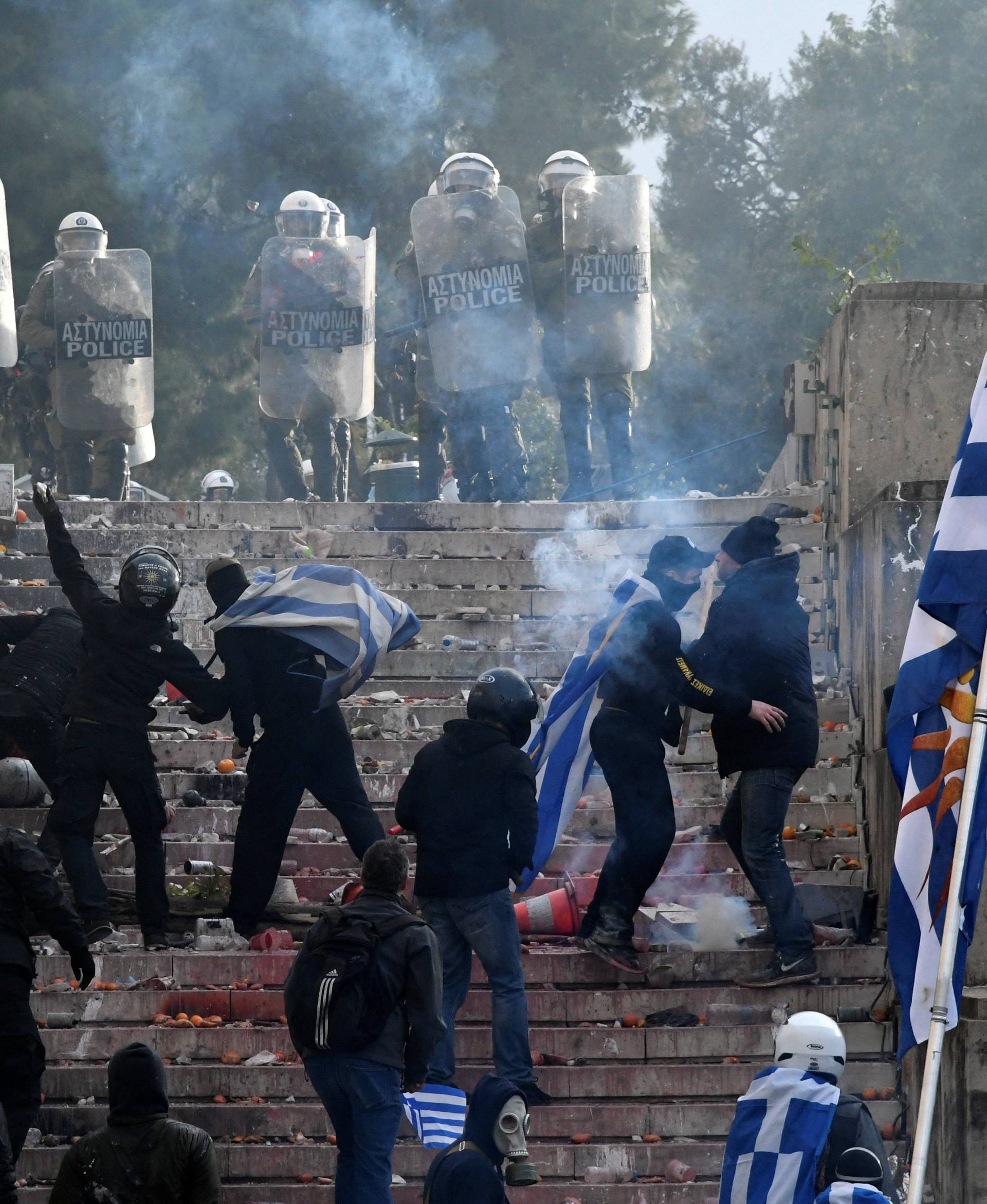Protesters clash with police officers during a demonstration against the agreement reached by Greece and Macedonia to resolve a dispute over the former Yugoslav republic's name, in Athens