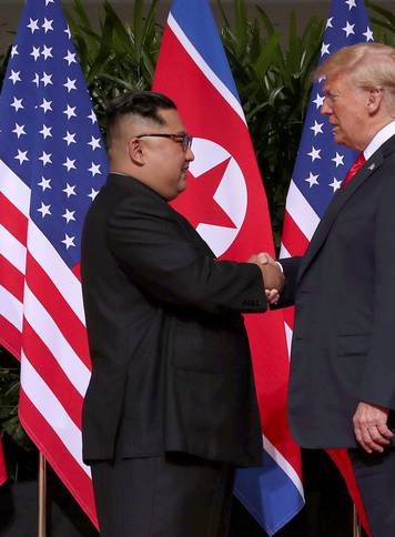 U.S. President Donald Trump shakes hands with North Korean leader Kim Jong Un at the Capella Hotel on Sentosa island in Singapore