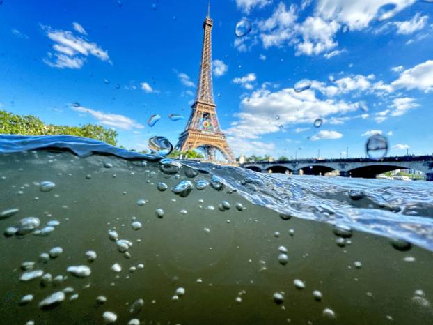 FILE PHOTO: FILE PHOTO: The Eiffel Tower is seen from the water of the Seine River as the Olympics opening ceremony rehearsal is postponed amid rainy weather.