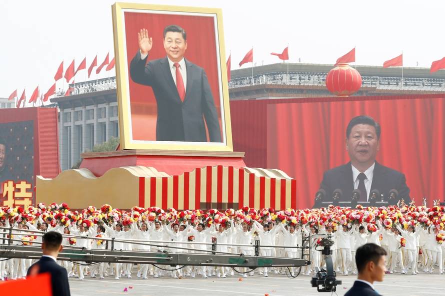 Performers travel past Tiananmen Square with a float showing Chinese President Xi during the parade marking the 70th founding anniversary of People's Republic of China