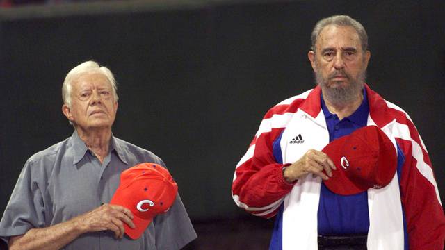 File photo of former U.S. President Jimmy Carter and then Cuban President Fidel Castro listening to the Cuban national anthem at the baseball stadium "Latinoamericano" in Havana