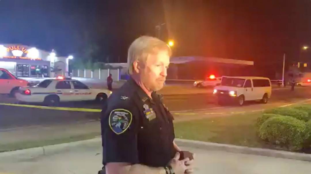 A police personnel speaks in the aftermath of a drive-by shooting at a liquor store in Shreveport, Louisiana