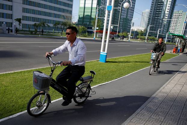 A man rides an electric bicycle at newly built Mirae Scientists Street in central Pyongyang