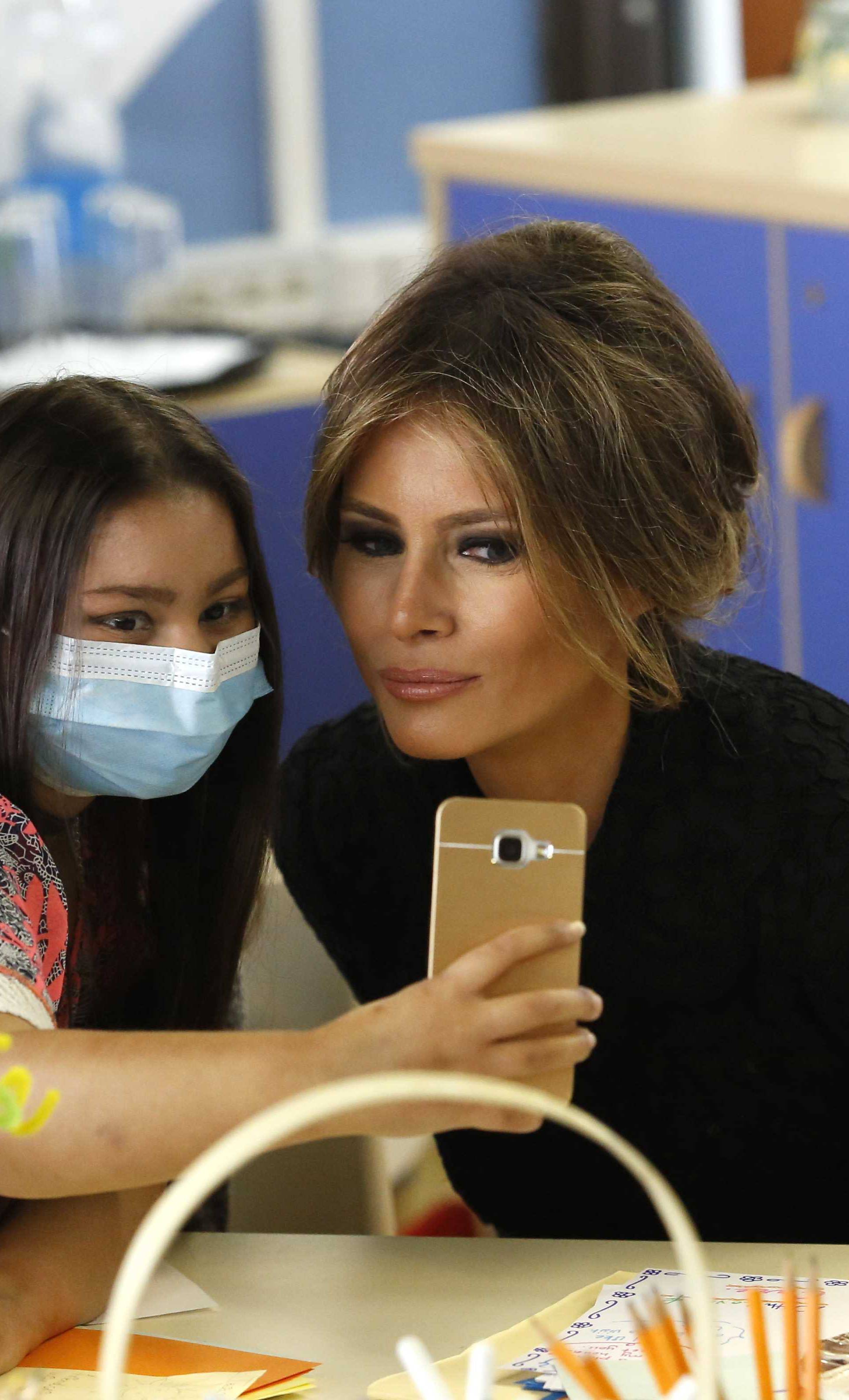 A girl takes a selfie with U.S. first lady Trump at the Bambino Gesu hospital in Rome