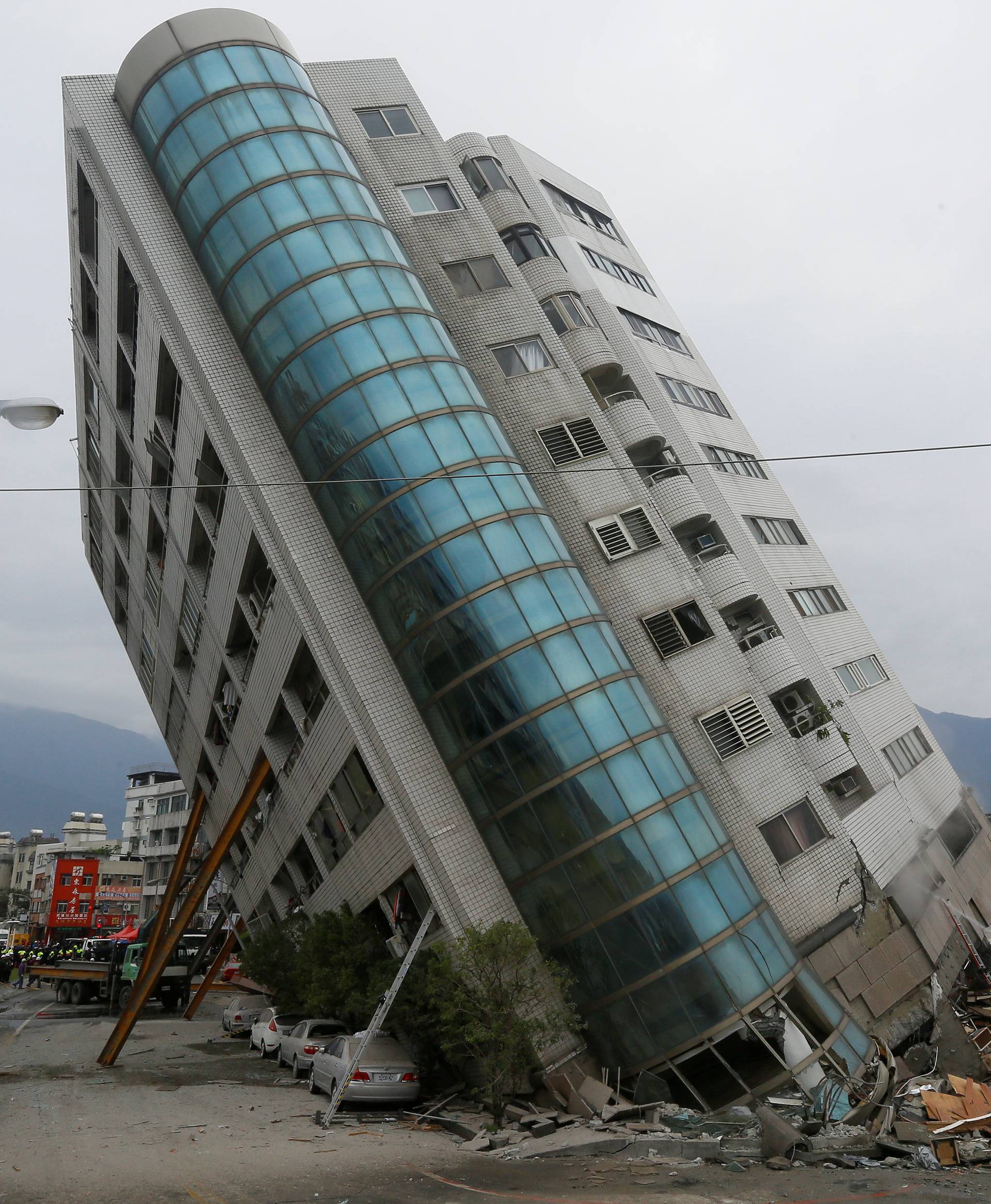 Rescue workers are seen by a damaged building after an earthquake hit Hualien