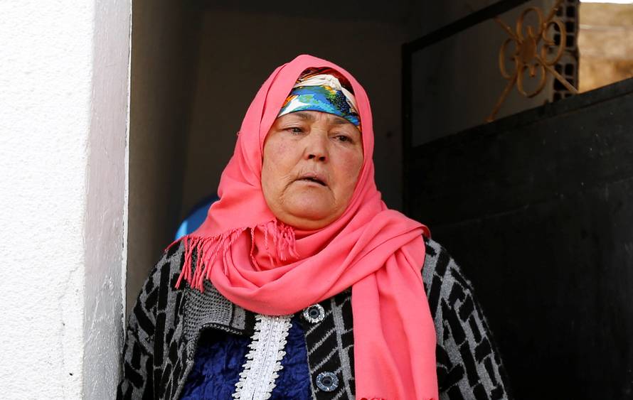 Nour, mother of suspect Anis Amri who is sought in relation with the truck attack on a Christmas market in Berlin, reacts near their home in Oueslatia, Tunisia