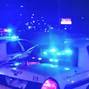 Police vehicles are seen near the scene in the aftermath of a drive-by shooting at a liquor store in Shreveport, Louisiana