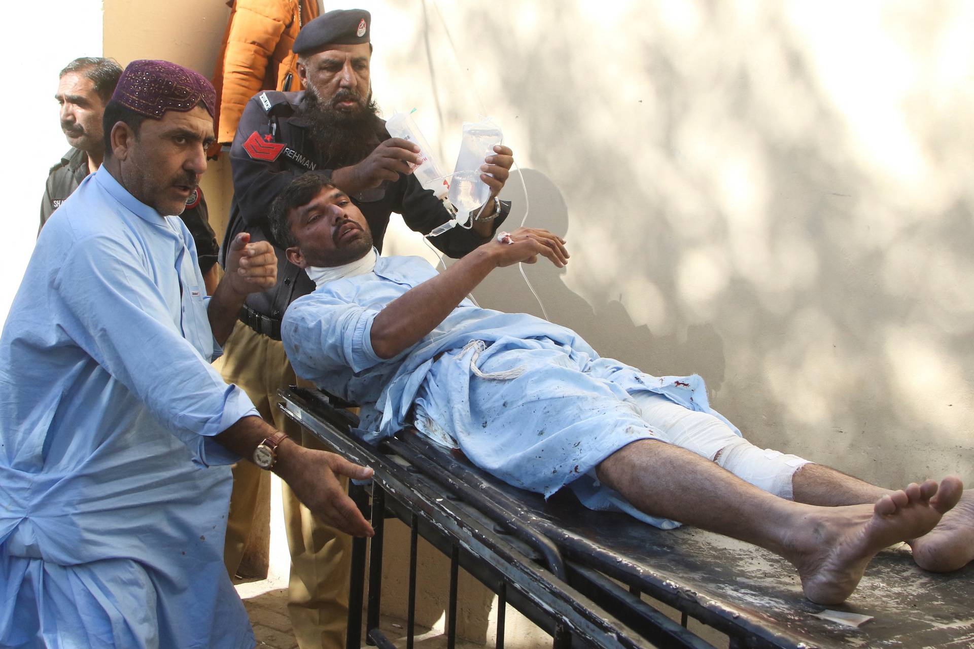 An injured man is shifted to hospital after a bomb blast at a railway station in Quetta