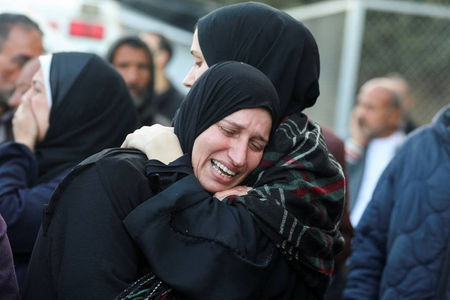 Palestinians mourn loved ones killed in Israeli strikes, in Deir Al-Balah in the central Gaza Strip