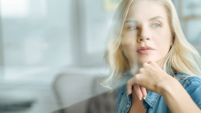 Portrait of pretty woman sitting in a living room