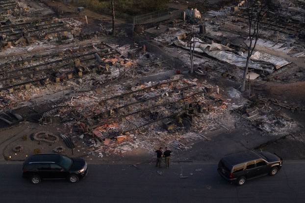 Security officials survey neighborhood left devastated by the Almeda fire in Phoenix, Oregon