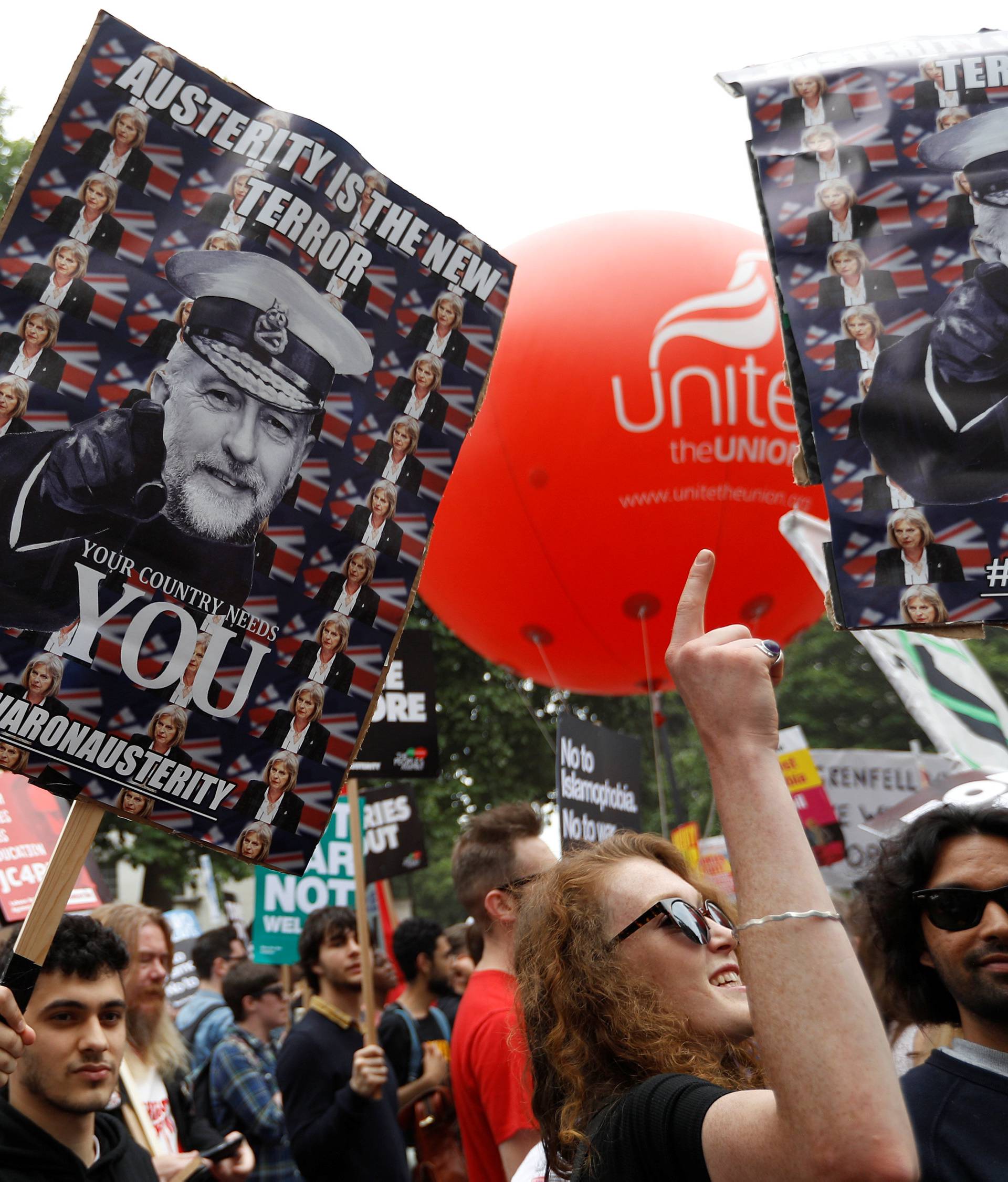 Demonstrators walk towards Parliament Square during an anti-austerity rally and march organised by campaigners Peoples' Assembly, in central London
