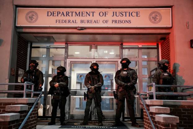 Department of Justice Federal Officers stand guard outside the Department of Justice next to the Metropolitan Detention Center in Brooklyn , New York