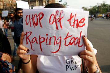 FILE PHOTO: A woman holds a placard during a protest against the rape of an eight-year-old girl in Kathua near Jammu, and a teenager in Unnao, Uttar Pradesh state, in Kolkata
