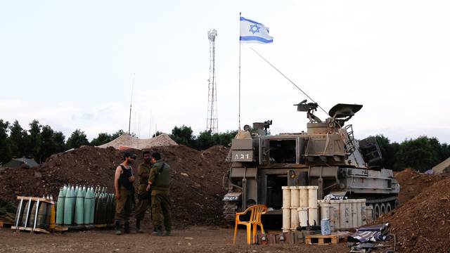 Soldiers chat at an Israeli artillery position near the Israel-Lebanon border