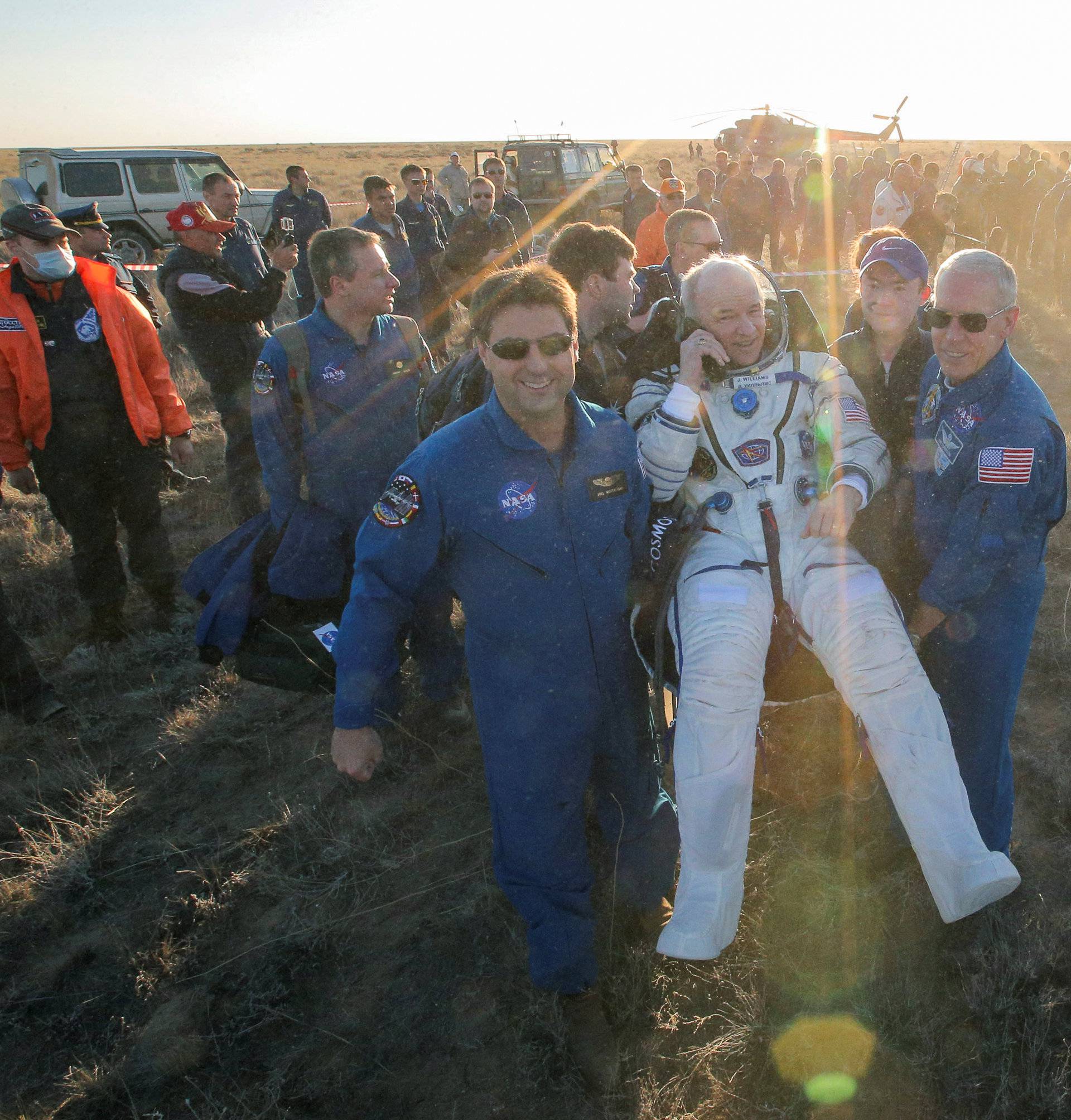 Ground personnel carry the International Space Station (ISS) crew member Jeff Williams of the U.S. after landing near the town of Zhezkazgan (Dzhezkazgan), Kazakhstan