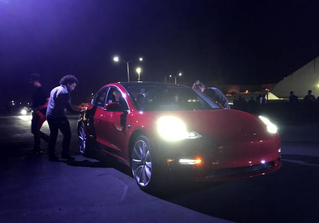 Customer employees receive some of the first Model 3 cars off the Fremont factory