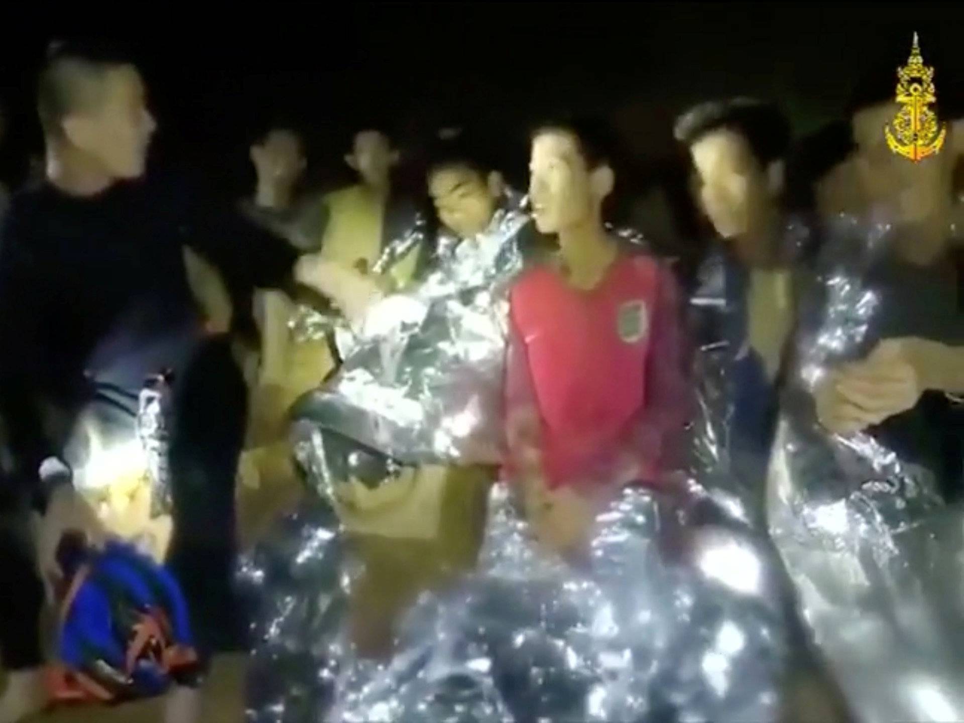 Boys from the under-16 soccer team trapped inside Tham Luang cave greet members of the Thai rescue team in Chiang Rai, Thailand