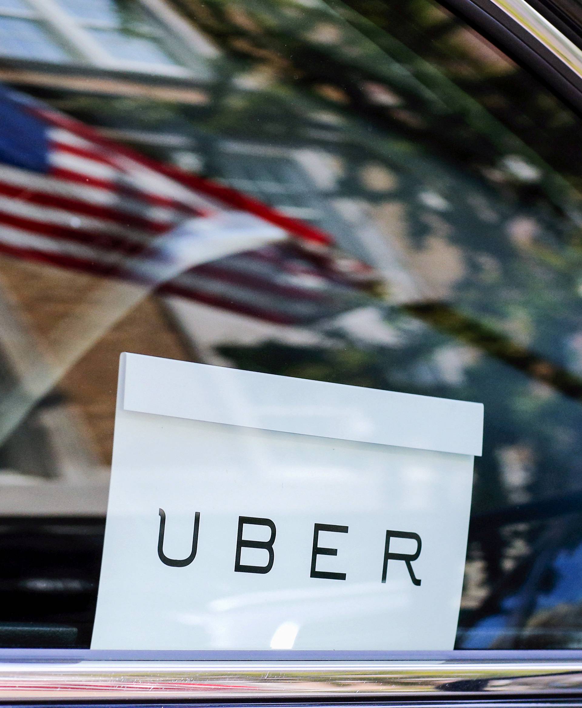 FILE PHOTO: An Uber sign is seen in a car in New York